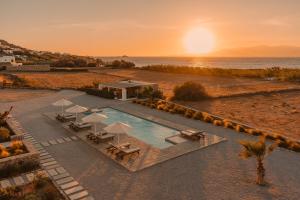 an overhead view of a swimming pool with a sunset at Archon Seaside Retreat in Plaka