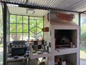 a kitchen with a stove and some windows at Habitación Suite Sami Llankay in Villa Ciudad Parque