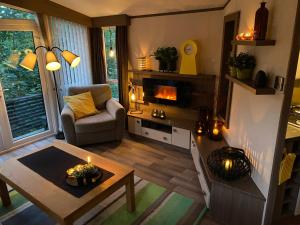 a living room with a table and a fireplace at Koie Holiday Home 3 in Stranda