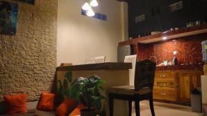 a kitchen with a table and a chair and a plant at Pranajaya oasis in Tejakula