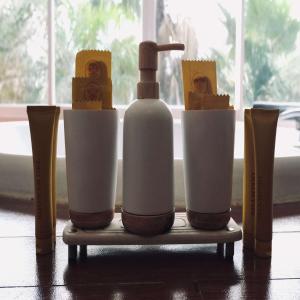 un estante con una botella de jabón y queso en Clove Hotel Bandung, en Bandung