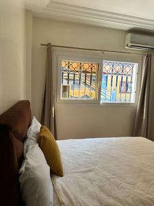 a bedroom with a bed and a window at Tradition & Tranquility in Tamraght Ouzdar +29 photos