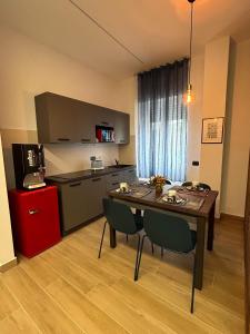 a kitchen with a table and chairs in a room at Casa Vacanze Luxury House Cassino in Cassino