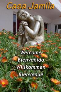 a statue of a woman sitting in a garden at Casa Jamila in El Alquián