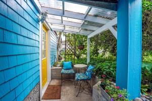 a patio with two chairs and a pergola at Artsy Private Guest Suite with Outdoor Saloon in Vancouver