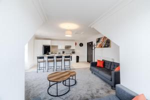 a living room with a couch and a table at Wild Berry Stays - Swan Street B in Angus