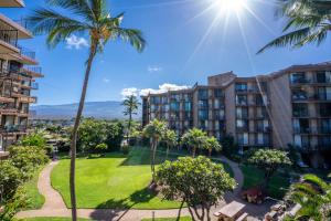 a view of a resort with palm trees and a park at Deluxe Oceanside Resort Vistas in Kihei