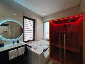 a bathroom with a tub and a red shower at Galactic&Ludmila Suite SPA in Braşov +93 photos