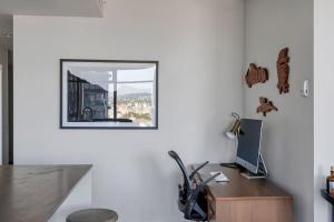 a desk with a computer and a mirror on a wall at The W, Modernized 2 bedroom Downtown Highrise in Vancouver