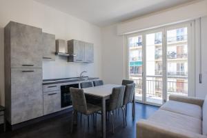 a kitchen and dining room with a table and chairs at Lungarno Apartment in Florence