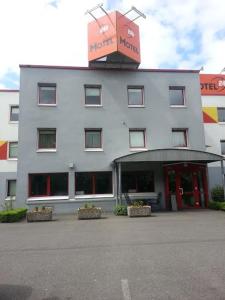 a large white building with a sign on top of it at Motel 24h Bremen in Bremen