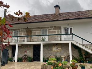 a building with a balcony on the side of it at Quinta da Capela in Celorico de Basto