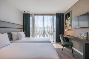 Voodi või voodid majutusasutuse Boutique Hotel Corona toas