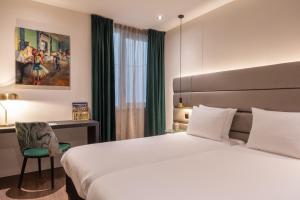 Voodi või voodid majutusasutuse Boutique Hotel Corona toas