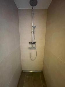 a shower in a bathroom with a shower head at Frohes Wochenende 22 in Boltenhagen +15 photos