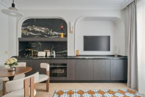 a living room with a television and a table at Nestay Les Halles in Paris