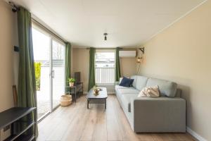 a living room with a couch and a table at 49, Efteling - Beekse Bergen - Dog Friendly in Oisterwijk