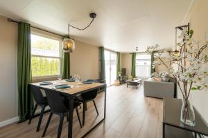 a dining room and living room with a table and chairs at 49, Efteling - Beekse Bergen - Dog Friendly in Oisterwijk