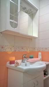 a bathroom with a sink and a mirror at Apartments Jasminka in Solin +29 photos