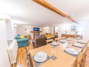 a dining room and living room with a dining table at Lakeland View in Keswick