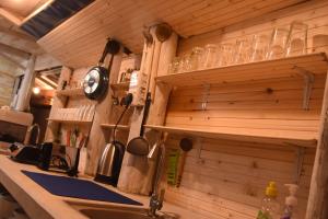 a kitchen with wooden walls and a counter with a sink at Muthu Villa 94 Midigama in Ahangama East