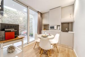 a kitchen and dining room with a table and chairs at Sé INN Studios by House and People in Braga +128 photos
