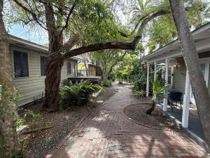 a brick walkway next to a house at Ibis Suite - Southernmost Sanctuary in Key West