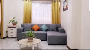 a living room with a blue couch and a table at LY residence unit 202 in Bacolod