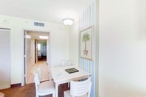 a room with a white desk and chairs at Camelot by the Sea 1506 in Myrtle Beach