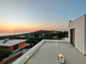 a view of the sunset from the roof of a house at Arillas Villas marilou in Arillas