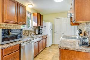 a kitchen with wooden cabinets and a stainless steel appliance at about 10 Mi to Dtwn Indianapolis Home with Game Room! in Indianapolis
