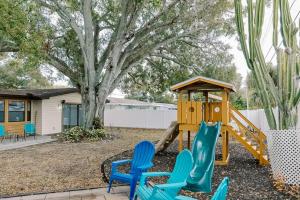 a playground with blue chairs and a slide at The Escape in Seminole