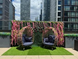 two wicker chairs in front of a wall of flowers at Fairfield Inn & Suites by Marriott New York Manhattan/Chelsea in New York