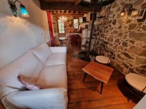 a living room with a white couch and a table at mare-monte in Evisa