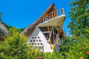 a house with a thatched roof at Villas Bambu in Barra de Navidad