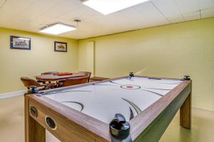 a ping pong table in a room with a table and chairs at about 10 Mi to Dtwn Indianapolis Home with Game Room! in Indianapolis