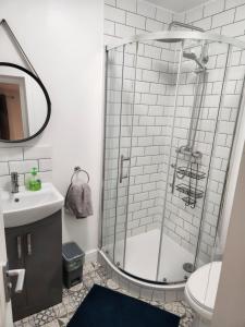 a bathroom with a shower and a sink at Beautiful stylish house near town centre in Rugby