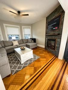 a living room with a couch and a fireplace at The Allen House - 3 Bedroom - 2 Full Bath - Private Gorgeous Apartment - Sleeps 8 in Albany