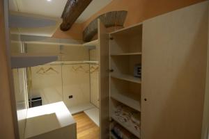 a small kitchen with white shelves and a ceiling at La Cervetta in Mantova +37 photos