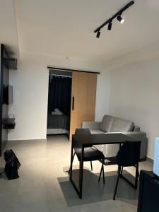 a living room with a table and a couch at Kit 122 Brasília in Brasilia