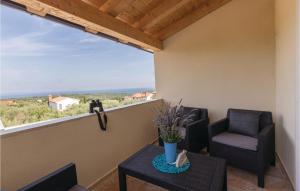 a balcony with two chairs and a table at Gorgeous Home In Peruski With Wifi in Peruški