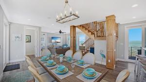 a dining room and living room with a table and chairs at Blue Horizon by Last Key Realty in Sugarloaf Shores +16 photos