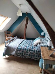 a bedroom with a bed in a attic at Maison accueillante à Petit-Caux avec jardin in Tocqueville-sur-Eu