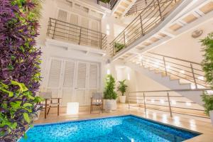 an indoor pool in a building with a staircase at Casa La Cartujita in Cartagena de Indias