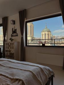 a bedroom with a window with a view of a building at Sarajevo Skyline Apartment in Sarajevo