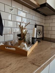 a wooden tray with plants and other items on a kitchen counter at Sarajevo Skyline Apartment in Sarajevo