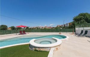 a swimming pool in a yard with two chairs at House Sole in Pula