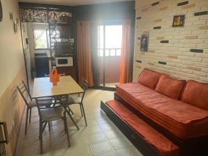 a living room with a couch and a table at SANBERJERE in San Bernardo