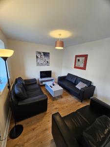 a living room with two couches and a table at Five Bedroom Apartment Athlone in Athlone
