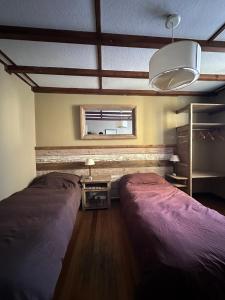 Postel nebo postele na pokoji v ubytování Bariloche Hostel